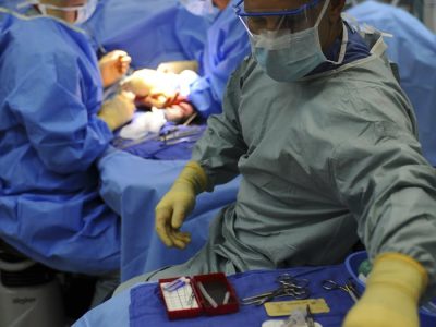 Team of surgeons in a hospital operating room conducting a surgery.